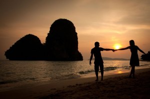 romantic girl and boy runs shore date