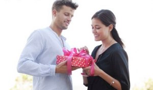 man gives gift to woman