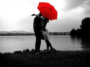 red umbrella kissing under